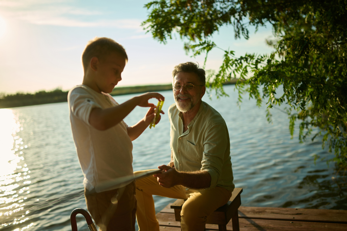 Grandfather and grandson fishing together